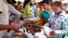 Cambodian garment workers buy some cheap food for their lunch in front of the factory in downtown of Phnom Penh, file photo. 