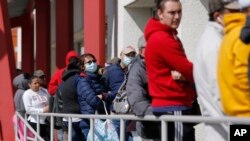 People wait in line for help with unemployment benefits at the One-Stop Career Center in Las Vegas, Nevada, March 17, 2020. 