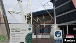 FILE - Coronavirus signs are seen in the city center as the coronavirus disease (COVID-19) outbreak continues in Cardiff, Wales, Britain, Oct. 19, 2020. 