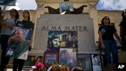 People with images of Fidel Castro gather one day after his death in Havana, Cuba, Nov. 26, 2016. Cuba will observe nine days of mourning for the former president.