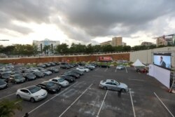 Movie audiences sit in their parked cars as they watch "Living in Bondage" at a drive-in cinema, following the relaxation of lockdown, amid the coronavirus disease (COVID-19) outbreak in Abuja, Nigeria, May 20, 2020.