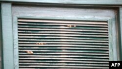 FILE - Prisoners' fingers are seen through a window after a riot by inmates in Lagos, Nigeria, Sept. 20, 2005. Correctional authorities said May 5, 2021, that an attack on Owerri prison in Imo state allowed 1,800 prisoners to escape. 