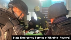 Rescuers and police officers carry an injured person out of a hospital hit by a Russian drone in Sumy, Ukraine, Sept. 28, 2024. (State Emergency Service of Ukraine via Reuters)