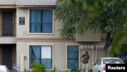 A worker powerwashes sidewalk in front The Ivy Apartments, where a man diagnosed with the Ebola virus was staying, Dallas, Texas, Oct. 2, 2014.