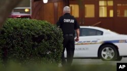 A police chaplain approaches the scene of shooting that killed 12 people in Virginia Beach, Va, May 31, 2019.