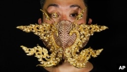 Edmond Kok, a Hong Kong theater costume designer and actor, wearing a face mask inspired by the decoration of Thai temple in Hong Kong, Aug. 6, 2020.