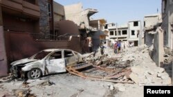People gather at the site of a car bomb attack in Kirkuk, 250 kilometers north of Baghdad, Iraq, Aug. 11, 2013.