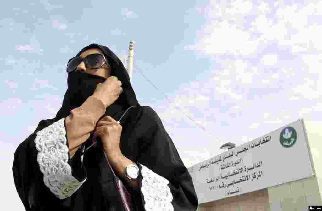 A Saudi woman leaves a polling station after casting her vote during municipal elections, in Riyadh, Saudi Arabia, Dec. 12, 2015.