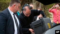 FILE - Police execute a search warrant on the home of an Australian intelligence officer in Canberra, Australia, Sept. 4, 2019. News Corp. Australia executive Campbell Reid linked the raid to the June 4 raid on journalist Annika Smethurst’s home.