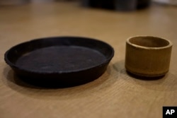A plate and cup made from food cement are seen at the laboratory of Tokyo University in Tokyo on May 26, 2022. (AP Photo/Chisato Tanaka)