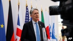 FILE - British Chancellor of the Exchequer Philip Hammond attends an interview during the G-7 finance ministers and central bank governors meeting in Chantilly, near Paris, July 18, 2019.
