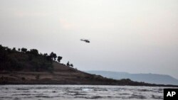 A helicopter on a search operation flies above the beach after more than a dozen college students were swept away at Murud on the Arabian Sea coast about 150 kilometers (95 miles) south of Mumbai, Maharashtra state, India, Monday, Feb. 1, 2016. Drowning is among the top five causes of death for children under 15 years in 48 of 85 countries surveyed.