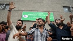 Demonstrators shout slogans outside a hospital emergency unit during a protest against the Indian government's scrapping of Kashmir's special status, in Srinagar, Aug. 9, 2019.