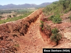 In this photo taken on Dec. 11, 2024 shows a large trench dug around the Sino Huijing Mine mountain to prevent rocks from rolling into the residents homes.