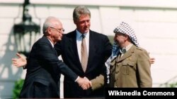 Israeli Prime Minister Yitzhak Rabin, U.S. President Bill Clinton, and Yasser Arafat at the Oslo Accords signing ceremony on 13 September 1993