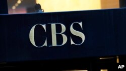 FILE - This Dec. 6, 2018, file photo shows the CBS logo at the entrance to its headquarters, in New York. 