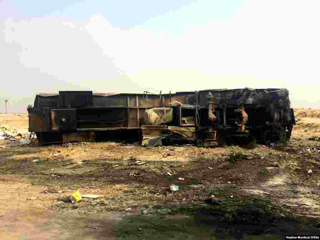 In regions recently cleared of IS fighters, homes lay in rubble, electric wires are cut, and burnt out vehicles scatter the landscape. October 24, 2016. (H.Murdock/VOA)