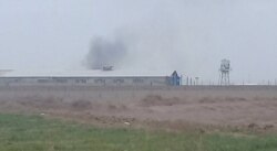 FILE - Smoke appears to rise from Qarchak women's prison near Tehran, in this photo first published online by Iranian Dervish news outlet Majzooban Noor on Feb. 8, 2019.