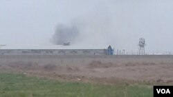 FILE - Smoke appears to rise from Qarchak prison near Tehran, Iran, in a photo first published online by Iranian Dervish news outlet Majzooban Noor on Feb. 8, 2019. The European Union put an asset freeze on the prison, one of the Iranian regime's detention facilities for women.