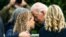 President Joe Biden, with first lady Jill Biden at right, consoles Miami-Dade County Mayor Daniella Levine Cava as he visits a memorial photo wall, near the partially collapsed Champlain Towers South condo building in Surfside, Fla., July 1, 2021. 