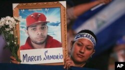A demonstrator holds a photo of a person who died during anti-government protests in Managua, Nicaragua, April 25, 2018. 