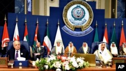 Emir of Kuwait, Sheikh Sabah al-Ahmad al-Sabah, right, and Secretary-General of the League of Arab States, Nabil El Araby, left, attend the closing session of the Arab League Summit at Bayan Palace, Kuwait, March 26, 2014.
