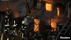 Rescuers work at a site of a Russian drone strike, amid Russia's attacks on Ukraine, in Odesa region, Ukraine, Dec. 27, 2023. (Press service of the State Emergency Service of Ukraine in Odesa region/Handout via Reuters)