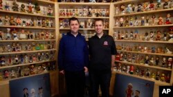 National Bobblehead Hall of Fame and Museum founders Brad Novak, left, and Phil Sklar, stand near the museum entrance at the National Bobblehead Hall of Fame and Museum in Milwaukee. (AP Photo/Carrie Antlfinger)