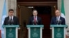 Ireland's Prime Minister Simon Harris (C), flanked by Ireland's Minister of Foreign Affairs Michel Martin (R) and Ireland's Minister for Transport Eamon Ryan (L), delivers a speech during a press conference, to recognise the state of Palestine at the Gove