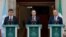 Ireland's Prime Minister Simon Harris (C), flanked by Ireland's Minister of Foreign Affairs Michel Martin (R) and Ireland's Minister for Transport Eamon Ryan (L), delivers a speech during a press conference, to recognise the state of Palestine at the Gove