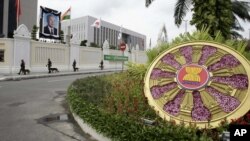 Cambodian security personnel patrol with their sniffing dogs under a portrait of Cambodia's late King Sihanouk placed in front of the Peace Palace during the Association of Southeast Asian Nations (ASEAN) Summit and related meetings in Phnom Penh, file photo. 