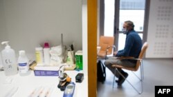 A patient attends a consultation with a general practitioner before receiving the AstraZeneca Covid-19 vaccine, in Gragnague near Toulouse, southern France, Feb. 26, 2021. 