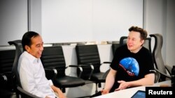 Indonesian President Joko Widodo reacts while talking with Founder and CEO of Tesla Motors Elon Musk during their meeting at the SpaceX launch site in Boca Chica, Texas