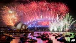 Fireworks explode over the Sydney Harbour during New Year's Eve celebrations in Sydney, Tuesday, Jan. 1, 2019. (Brendan Esposito/AAP via AP)