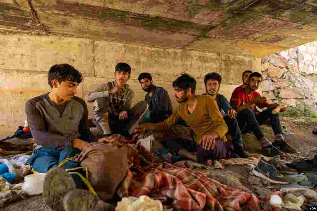 Under a bridge in eastern Turkey, refugees wait for a smuggler to pick them up and guide them to what they hope is a safe location, Aug. 31, 2021. 