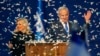 Israeli Prime Minister Benjamin Netanyahu and his wife, Sara, address supporters as confetti falls upon them at the Likud party campaign headquarters in the coastal city of Tel Aviv, after polls officially closed. 
