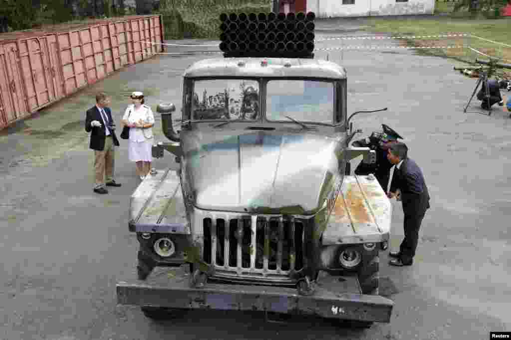 A foreign military attache inspects a multiple rocket launcher from pro-Russian separatists in the eastern region of Ukraine, Aug. 29, 2014.&nbsp;
