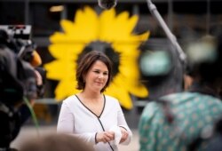 FILE - Germany's Green party co-chair, Annalena Baerbock, a candidate for chancellor, gives an interview before her party's federal delegates' conference, in Berlin, Germany, June 10, 2021.