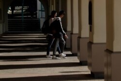 Students walk on the San Diego State University campus Thursday, March 12, 2020, in San Diego.