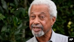 Tanzanian writer Abdulrazak Gurnah gestures as he poses for a photo at his home in Canterbury, England, Oct. 7, 2021.