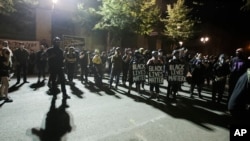 A crowd gathers during a Black Lives Matter protest at the Mark O. Hatfield United States Courthouse in Portland, Ore, July 30, 2020, as after days of clashes with federal police, the crowd remained peaceful.