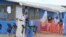 FILE - Boys stand in the "red zone" where they are being treated for Ebola at the Bong County ebola treatment unit about 200 km east of Monrovia, Liberia, Oct. 28, 2014. 