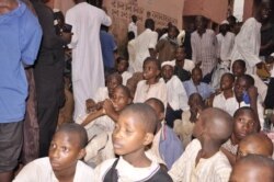 Young men and boys watch as staff members get interrogated during a police raid at an Islamic school in Kaduna, Nigeria, Sept. 26, 2019. (Courtesy - Nigerian Police)