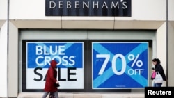 FILE - People walk past a Debenhams store in Stockport, Britain, Jan. 4, 2018. 