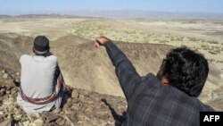 A local resident shows a mountain at the Koh-e-Sabz area of Pakistan's southwest Baluchistan province where Iran launched an airstrike, on Jan. 18, 2024.