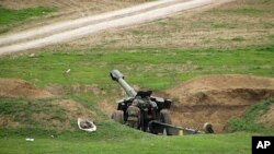 Armenian soldiers aim a howitzer, April 3, 2016, in the village of Mardakert, in the separatist region of Nagorno-Karabakh.