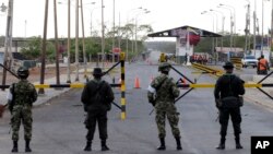 FILE - Colombian police officers and soldiers patrol the border between Colombia and Venezuela, in Paraguachon, Colombia, Sept. 9, 2015. The U.N. human rights office is asking for the release of 59 Colombian nationals being detained in Venezuela. 