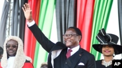 FILE - Malawi's newly elected President Lazarus Chakwera greets supporters after being sworn in in Lilongwe, Malawi, June 28 2020. 
