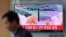 A man walks past a TV screen showing a local news program about North Korea's reported firing of an ICBM, at Seoul Train Station in Seoul, South Korea, July 5, 2017.