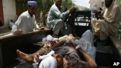 Pakistani villagers help victims from a blast to a district hospital in Landi Kotal Pakistan Afghanistan border, Saturday, June 16, 2012.